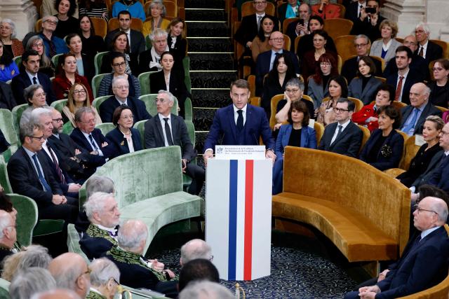 France's President Emmanuel Macron (C) delivers a speech during the solemn session of presentation of the 9th edition of the Dictionnaire de l'Academie Francaise (Dictionary of the French Academy), which is the official dictionary of the French language in Paris on November 14, 2024. (Photo by Ludovic MARIN / POOL / AFP)