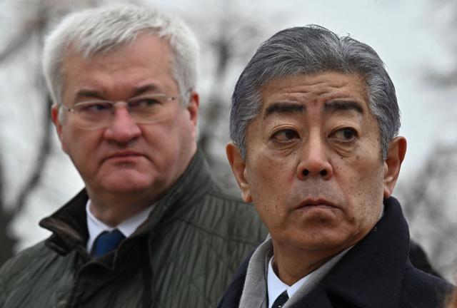 Ukraine's Foreign Minister Andrii Sybiha (L) and Japan's Foreign Minister Takeshi Iwaya stand outside the Saint Michael's Cathedral in Kyiv, on November 16, 2024, amid the Russian invasion of Ukraine. (Photo by Sergei SUPINSKY / AFP)