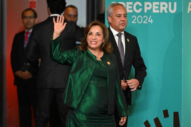 Peru's President Dina Boluarte waves upon arrival at the APEC Economic Leaders’ Meeting (AELM) at the Convention Centre in Lima, on November 16, 2024. (Photo by Luis ACOSTA / AFP)