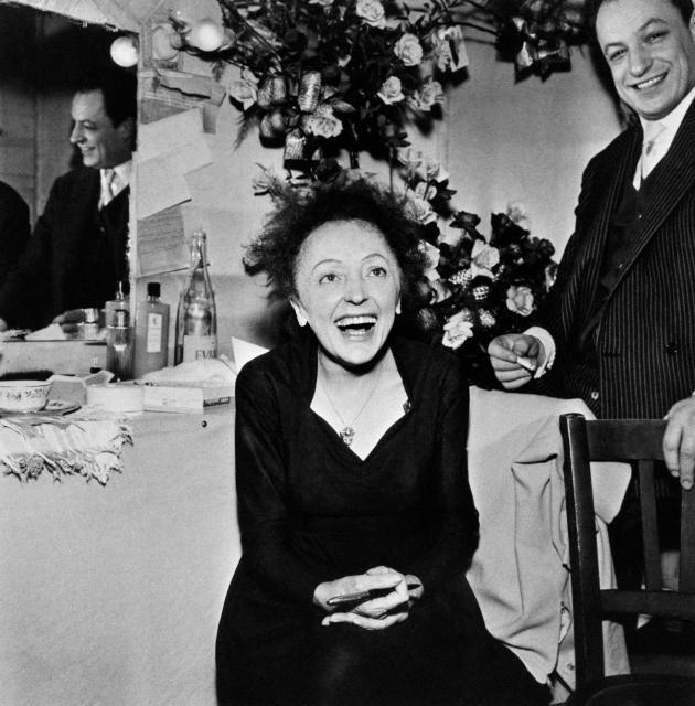 (FILES) French singer Edith Piaf smiles after her show at Olympia concert hall beside her lyrics writer Charles Dumont (R) in Paris on December 30, 1960. Musician Charles Dumont, composer of Edith Piaf's legendary "Je ne regrette rien", died in the night from November 17, 2024 to November 18, 2024 in Paris at the age of 95, his partner Florence announced to AFP. This singer-songwriter, who had also collaborated with Barbra Streisand, died following a long illness at his home. (Photo by AFP)