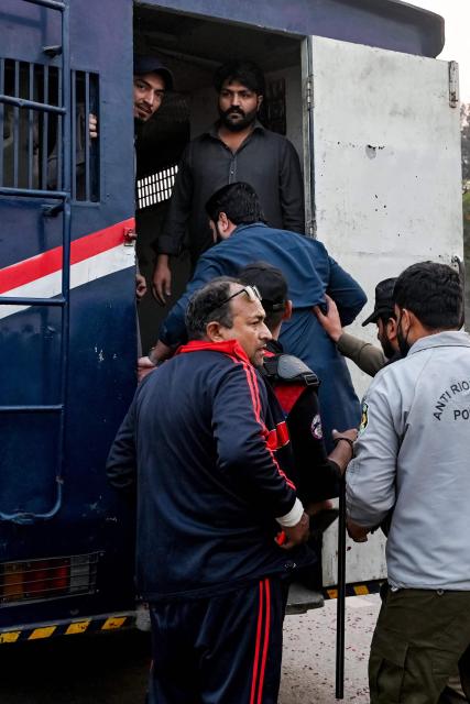 Security personnel detain a supporter of jailed former prime minister Imran Khan's Pakistan Tehreek-e-Insaf (PTI) party during a protest demanding his release, in Lahore on November 24, 2024. Pakistan's capital was under total lockdown on November 24, with mobile internet cut and thousands of police flooding the streets as supporters of jailed ex-prime minister marched on the city. (Photo by Arif ALI / AFP)