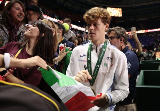 Italy's Jannik Sinner signs autographs after his team's victory over Netherlands in the Davis Cup Finals at the Palacio de Deportes Jose Maria Martin Carpena arena in Malaga, southern Spain, on November 24, 2024. (Photo by Thomas COEX / AFP)