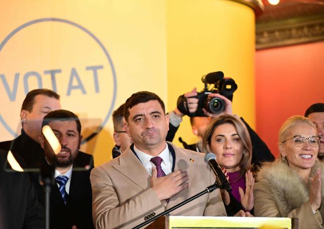 George Simion (C), presidential candidate and leader of the Alliance for the Union of Romanians (AUR) party reacts after the announcment of exit polls at the party's headquarters in Galbinasi, north east of Bucharest, Romania on November 24, 2024. Pro-European Social Democrat Prime Minister Marcel Ciolacu was leading in first round of Romania's presidential election, according to two exit polls released soon after the end of voting.
Ciolacu scored 25 percent of the vote while the centre-right former journalist turned small-town mayor Elena Lasconi was on 18 percent, according to the polls. Two far-right candidates scored 15 and 16 percent. (Photo by Daniel MIHAILESCU / AFP)