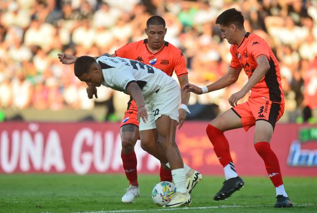 Olimpia's forward #30 Hugo Benitez and Nacional's defender #03 Alexis Canete fight for ball during the Paraguayan football league final football match between Olimpia and Nacional at Defensores del Chaco Stadium in Asuncion on November 24, 2024. (Photo by Daniel Duarte / AFP)