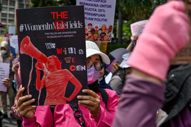 Activists take part in a street protest on the International Day for the Elimination of Violence Against Women, in Jakarta on November 25, 2024. (Photo by BAY ISMOYO / AFP)