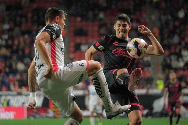 Atlas' forward #32 Uros Durdevic and Tijuana's defender #15 Diego Zaragoza fight for the ball during the Liga MX Apertura tournament football match between Tijuana and Atlas at Caliente Stadium in Tijuana, Baja California State, Mexico, on November 24, 2024. (Photo by Guillermo Arias / AFP)