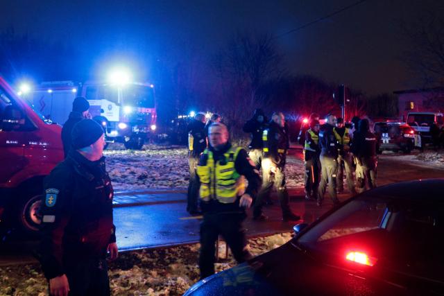 Lithuanian law enforcement officers work at the crash site of a cargo plane near the Vilnius International Airport in Vilnius on November 25, 2024. (Photo by Petras MALUKAS / AFP)