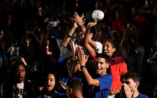 Young Cubans participate in the vigil for the 8th anniversary of Cuban late leader Fidel Castro's physical disappearance in Havana on November 25, 2024. (Photo by YAMIL LAGE / AFP)