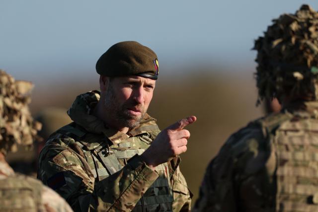 Britain's Prince William, Prince of Wales (C) points as he talks with members of a drone flying squad from the 1st Battalion Welsh Guards during his visit to an Army firing range facility on Salisbury Plain, in southern England on November 26, 2024. (Photo by Adrian Dennis / AFP)