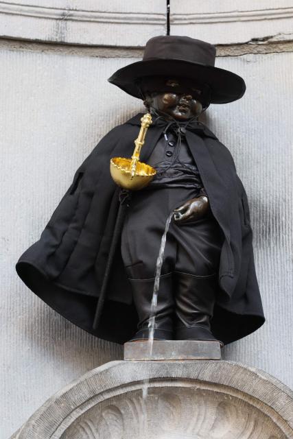 This photograph shows the Manneken Pis sculpture with a Zorro costume, as a tribute to the fictional character Zorro, created in 1919 and portrayed by French actor Jean Dujardin in a new television series, after an award ceremony for the City of Brussels Medal of Recognition, in Brussels, on November 28, 2024. (Photo by BENOIT DOPPAGNE / Belga / AFP) / Belgium OUT