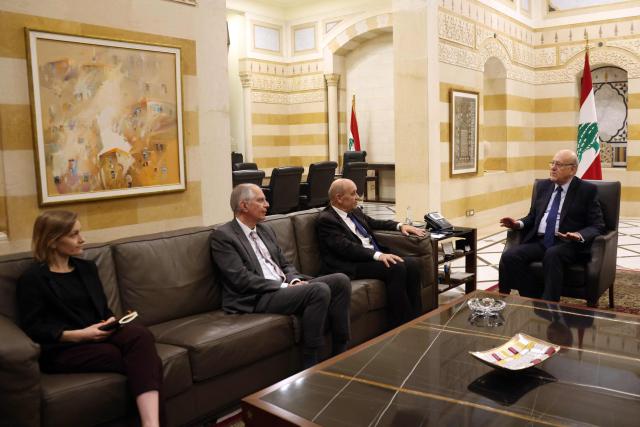 France's ambassador to Lebanon Herve Magro (2-L) and French envoy to Lebanon Jean-Yves Le Drian (L) meet with Lebanon's caretaker Prime Minister Najib Mikati (R) in Beirut on November 28, 2024. Part of the November 28 Lebanese parliament session was attended by Le Drian, who arrived a day earlier for talks with senior Lebanese officials. (Photo by IBRAHIM AMRO / AFP)