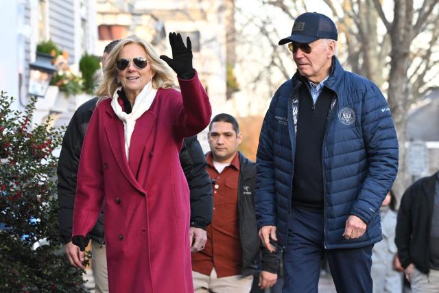 US First Lady Jill Biden (L) waves as she and US President Joe Biden walk to a bookstore after having lunch at the Brotherhood of Thieves restaurant in Nantucket, Massachusetts, on November 29, 2024. Biden and family are in Nantucket, Massachusetts, for the Thanksgiving holiday. (Photo by Mandel NGAN / AFP)