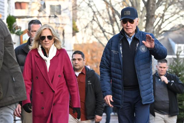 US President Joe Biden (R) waves as he and US First Lady Jill Bidend walk to a bookstore after having lunch at the Brotherhood of Thieves restaurant in Nantucket, Massachusetts, on November 29, 2024. Biden and family are in Nantucket, Massachusetts, for the Thanksgiving holiday. (Photo by Mandel NGAN / AFP)