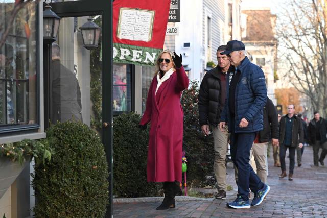 US First Lady Jill Biden (L) waves as she and US President Joe Biden walk to a bookstore after having lunch at the Brotherhood of Thieves restaurant in Nantucket, Massachusetts, on November 29, 2024. Biden and family are in Nantucket, Massachusetts, for the Thanksgiving holiday. (Photo by Mandel NGAN / AFP)