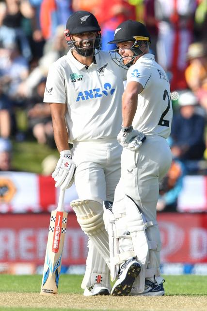 New Zealand's Daryl Mitchell (L) and Glenn Phillips look on during the third day of the first Test cricket match between New Zealand and England at Hagley Oval in Christchurch on November 30, 2024. (Photo by Sanka Vidanagama / AFP)