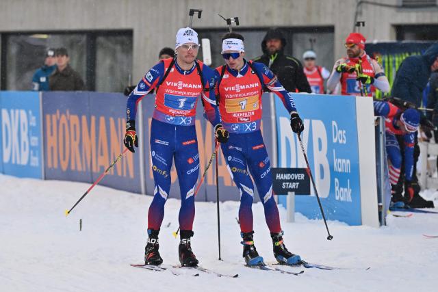 France's Emilien Jacquelin (L) and France's Eric Perrot compete during the men's 4x7,5km relay event of the IBU Biathlon World Cup in Hochfilzen, Austria, on December 15, 2024. (Photo by KERSTIN JOENSSON / AFP)