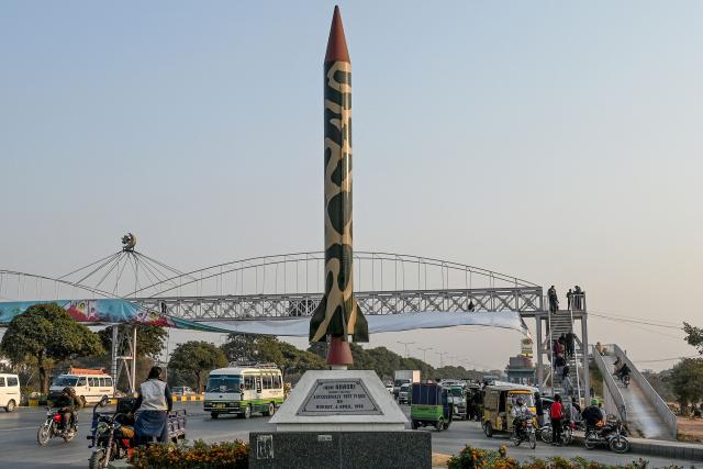 Commuters ride past a replica of Pakistan's 'Ghauri' ballistic missile along a road in Islamabad on December 19, 2024. Pakistan's government said on December 19, US sanctions imposed on state-owned and private companies over its long-range ballistic missile programme were "biased" and had "dangerous implications" for regional stability. (Photo by Farooq NAEEM / AFP)