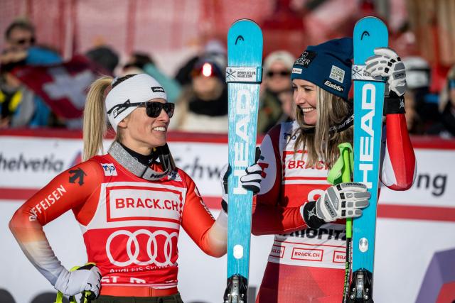 Second placed Switzerland's Lara Gut-Behrami (L) speaks with first placed Austria's Cornelia Huetter during the podium ceremony of the Women's Super-G race as part of the FIS Alpine ski World Cup 2024-2025, in St. Moritz on December 21, 2024. (Photo by Fabrice COFFRINI / AFP)