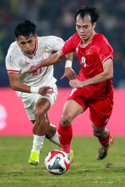 Vietnam's Nguyen Toan Van (R) and Myanmar's Ye Yint Aung vie for the ball during the 2024 ASEAN Electric Cup group B football match between Vietnam and Myanmar at the Viet Tri stadium in Phu Tho province on December 21, 2024. (Photo by Lam THOA / AFP)