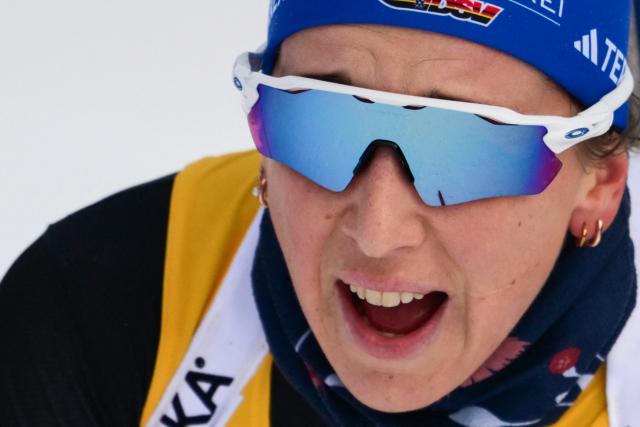 Germany's Franziska Preuss celebrates as she crosses the line and wins the women's 10km pursuit event of the IBU Biathlon World Cup in Le Grand Bornand near Annecy, southeastern France, on December 21, 2024. (Photo by Olivier CHASSIGNOLE / AFP)