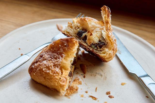 A croissant dough mince pie is pictured at Pophams bakery in London on December 20, 2024. "We have great respect for the classic shortcrust mince pie, but we believe in the power of innovation — especially when it creates something so delicious," said Pophams' creative director Lucy McWhirter. The bakery uses its signature croissant dough for a mince pie filled with classic mincemeat and citrus and ginger flavoured cream. (Photo by BENJAMIN CREMEL / AFP)