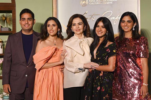 Nita Ambani (C), wife of billionaire tycoon Mukesh Ambani and chairperson and founder of the Reliance Foundation with her son Akash Ambani (L), daughters-in-law Shloka Mehta (2L), Radhika Merchant (2R) and daughter Isha Ambani poses during an exclusive preview night of 'NMACC Arts Cafй’ near the Nita Mukesh Ambani Cultural Centre (NMACC) in Mumbai on December 21, 2024. (Photo by Sujit JAISWAL / AFP)