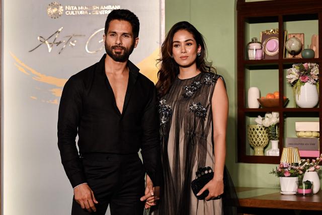 Bollywood actor Shahid Kapoor (L) with his wife Mira Rajput poses during an exclusive preview night of 'NMACC Arts Cafй’ near the Nita Mukesh Ambani Cultural Centre (NMACC) in Mumbai on December 21, 2024. (Photo by Sujit JAISWAL / AFP)