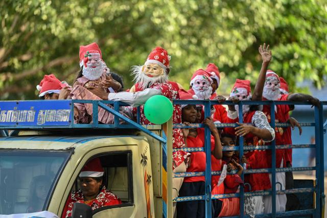 Children and parents dressed as Santa Claus arrive to participate in an event as a part of Christmas celebrations in Chennai on December 22, 2024. (Photo by R.Satish BABU / AFP)