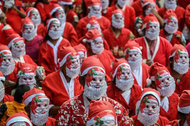 People dressed as Santa Claus gather for an event as a part of Christmas celebrations in Chennai on December 22, 2024. (Photo by R.Satish BABU / AFP)