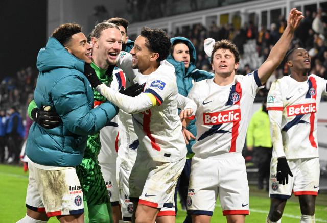 Paris Saint-Germain's Brazilian defender #05 Marquinhos (C) celebrates with Paris Saint-Germain's Russian goalkeeper #39 Matvey Safonov (2nd L) at the end of the French Cup round of 64 football match between Lens and  Paris Saint-Germain, at the Bollaert-Delelis Stadium in Lens, northern France, on December 22, 2024. (Photo by FRANCOIS NASCIMBENI / AFP)