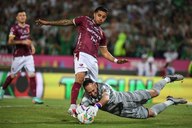 Nacional's goalkeeper #01 David Ospina and Tolima's midfielder #10 Yeison Guzman fight for the ball during the Colombian League second leg football final match between Atletico Nacional and Deportes Tolima at the Atanasio Girardot Stadium in Medellin, Colombia on December 22, 2024. (Photo by Jaime SALDARRIAGA / AFP)