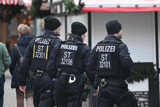 Policemen patrol past closed Christmas market shops days after a car-ramming attack on the Christmas market in Magdeburg, eastern Germany, on December 23, 2024. Magdeburg has been in deep mourning over the mass carnage on Friday evening, December 20, 2024, when an SUV smashed through a crowd at its Christmas market, killing four women and a nine-year-old child and injuring 205 people. Political pressure has built on the question of potential missed warnings about Saudi suspect Taleb al-Abdulmohsen, a 50-year-old psychiatrist who had made online deaths threats and previously had trouble with the law. (Photo by RALF HIRSCHBERGER / AFP)