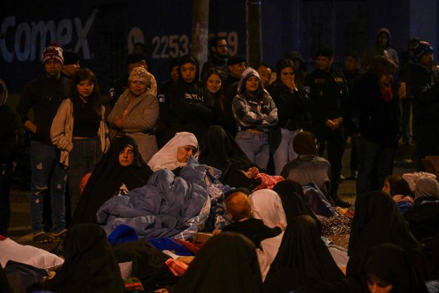 Family members and some of the children who were rescued from the Jewish sect Lev Tahor and taken to a shelter are held by police after they attempted to leave the facility in Guatemala City on December 23, 2024. Relatives of the 160 children who were rescued from the ultra-Orthodox Jewish Lev Tahor sect, under investigation for alleged sexual abuse of minors, gathered outside a shelter in the capital to demand that the authorities return them. The family members, who belong to the sect, stood on a street in front of the headquarters of the Alida Espana Special Care Center for Children, where the children were taken. According to the Attorney General's Office (PGN), the members of the sect "broke into" the center where the minors were being held, "taking away" several of them, but with the help of the police, they "managed to locate and return all of them to safety." (Photo by JOHAN ORDONEZ / AFP)