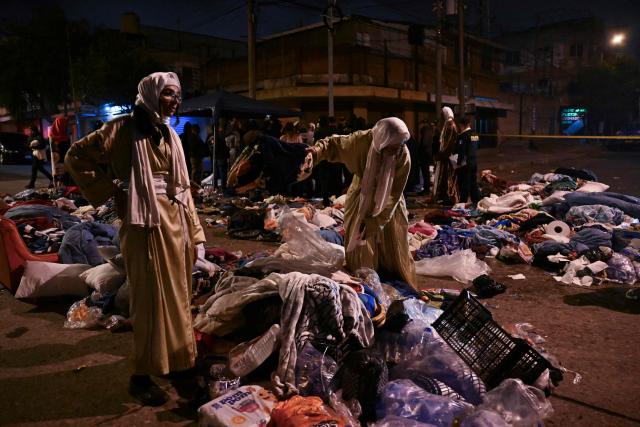 Women remain next to the belongings of family members and some of the children who were rescued from the Lev Tahor Jewish sect and taken to a shelter following their recapture by police after attempting to leave the facility in Guatemala City on December 23, 2024. Relatives of the 160 children who were rescued from the ultra-Orthodox Jewish Lev Tahor sect, under investigation for alleged sexual abuse of minors, gathered outside a shelter in the capital to demand that the authorities return them. The family members, who belong to the sect, stood on a street in front of the headquarters of the Alida Espana Special Care Center for Children, where the children were taken. According to the Attorney General's Office (PGN), the members of the sect "broke into" the center where the minors were being held, "taking away" several of them, but with the help of the police, they "managed to locate and return all of them to safety." (Photo by JOHAN ORDONEZ / AFP)