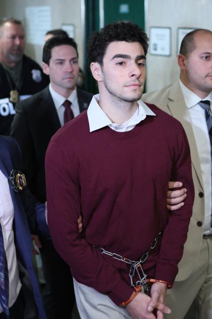 Luigi Nicholas Mangione (C) arrives at Manhattan Criminal Court in New York on December 23, 2024. Mangione, 26, is accused of shooting UnitedHealthcare chief executive Brian Thompson on a Manhattan street on December 4. (Photo by CHARLY TRIBALLEAU / AFP)