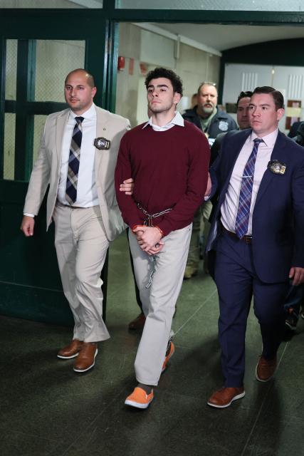 Luigi Nicholas Mangione (C) arrives at Manhattan Criminal Court in New York on December 23, 2024. Mangione, 26, is accused of shooting UnitedHealthcare chief executive Brian Thompson on a Manhattan street on December 4. (Photo by CHARLY TRIBALLEAU / AFP)