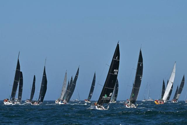 Yachts compete at the start of the Sydney to Hobart yacht race as they leave Sydney Harbour in Sydney on December 26, 2024. (Photo by Saeed KHAN / AFP)