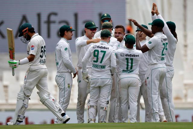 South Africa's Dane Paterson (c) celebrates with teammates after the dismissal of Pakistan's Babar Azam (L) during the first day of the first cricket Test match between South Africa and Pakistan at SuperSport Park in Centurion on December 26, 2024. (Photo by PHILL MAGAKOE / AFP)