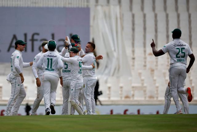 South Africa's Dane Paterson (2nd R) celebrates with teammates after the dismissal of Pakistan's Babar Azam (unseen) during the first day of the first cricket Test match between South Africa and Pakistan at SuperSport Park in Centurion on December 26, 2024. (Photo by PHILL MAGAKOE / AFP)