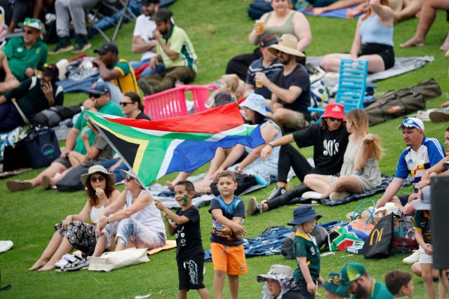 A child waves a South Arican flag during the first day of the first cricket Test match between South Africa and Pakistan at SuperSport Park in Centurion on December 26, 2024. (Photo by PHILL MAGAKOE / AFP)