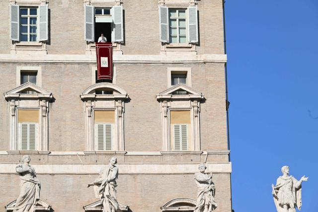 Pope Francis stands at the window of the apostolic palace overlooking St. Peter's square for the Angelus prayer on December 26, 2024 in The Vatican. (Photo by Alberto PIZZOLI / AFP)