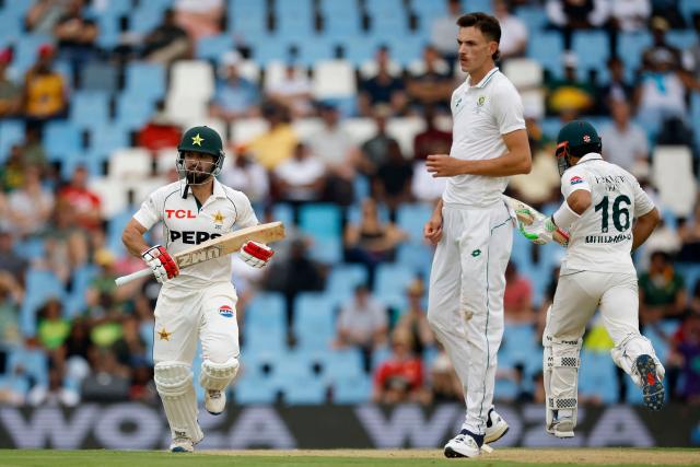 Pakistan's Mohammad Rizwan (L) and Pakistan's Kamran Ghulam (R) run between wickets as South Africa's Marco Jansen looks on during the first day of the first cricket Test match between South Africa and Pakistan at SuperSport Park in Centurion on December 26, 2024. (Photo by PHILL MAGAKOE / AFP)