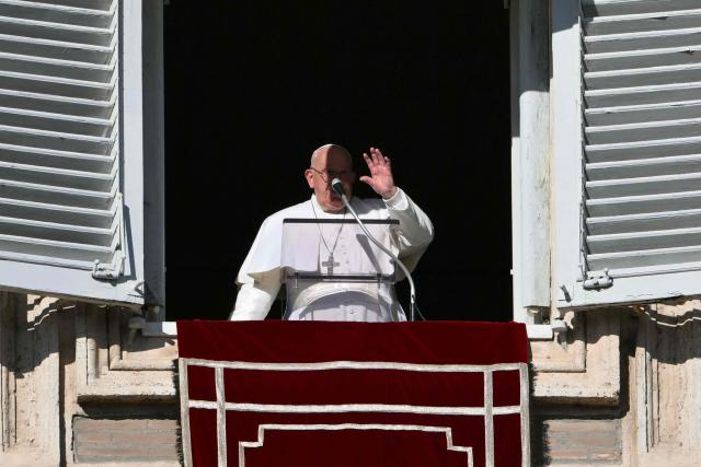 Pope Francis waves from the window of the apostolic palace overlooking St. Peter's square for the Angelus prayer on December 26, 2024 in The Vatican. (Photo by Alberto PIZZOLI / AFP)