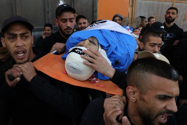 Mourners carry the body of Palestinian, killed alongside six others in an Israeli raid, during their funeral in the Tulkarem camp for Palestinian refugees in the occupied West Bank on December 26, 2024. (Photo by AFP)