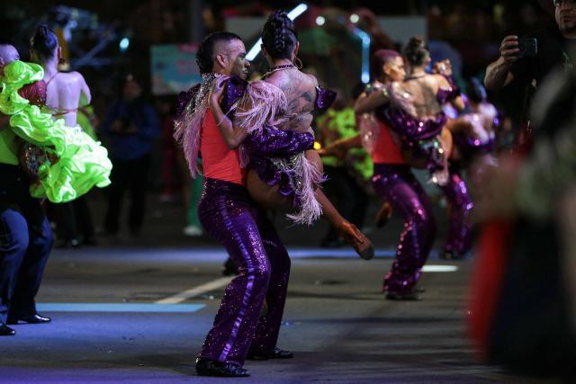 Members of a salsa school perform during a parade in the framework of the Fair of Cali at the Salsodromo in Cali, Colombia, on December 25, 2024. (Photo by Lusef ROJAS / AFP)