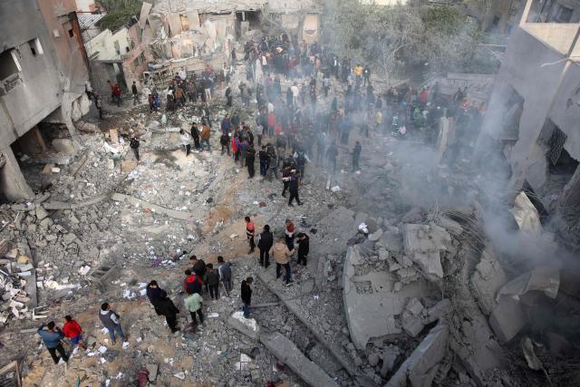 Civilians check the site of an Israeli strike in a residential area at Tuffah neighbourhood, east of Gaza City, on December 26, 2024, amid the ongoing war between Israel and the Palestinian Hamas movement. The health ministry in Hamas-run Gaza said on December 26, that 38 people had been killed in the Palestinian territory in the past 24 hours, taking the overall war death toll to 45,399. (Photo by Omar AL-QATTAA / AFP)