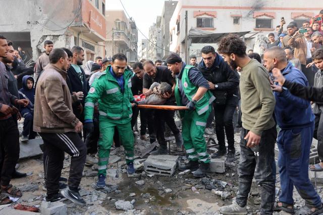 Rescuers evacuate a wounded child at the site of an Israeli strike in a residential area in the Tuffah neighbourhood, east of Gaza City, on December 26, 2024, amid the ongoing war between Israel and the Palestinian Hamas movement. The health ministry in Hamas-run Gaza said on December 26, that 38 people had been killed in the Palestinian territory in the past 24 hours, taking the overall war death toll to 45,399. (Photo by Omar AL-QATTAA / AFP)