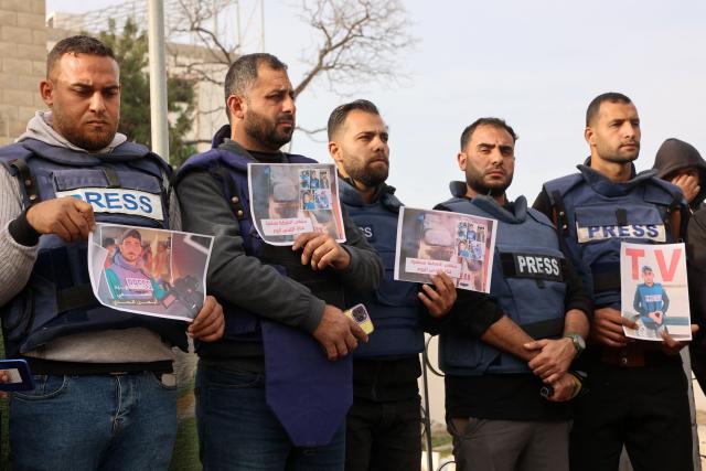 Members of the press stand in solidarity after an Israeli missile hit a media broadcast truck in Nuseirat, on December 26, 2024, outside the Baptist Hospital in Gaza City, amid the ongoing war between Israel and the Palestinian Hamas movement. Palestinian TV channel affiliated with a militant group said five of its journalists were killed on December 26, in an Israeli strike on their vehicle in Gaza, with Israel's military saying it had targeted a "terrorist cell". (Photo by Omar AL-QATTAA / AFP)