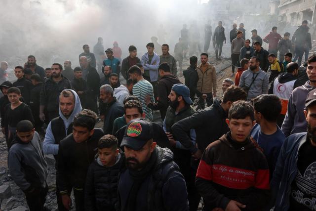 People stand at the site of an Israeli strike in a residential area in the Tuffah neighbourhood, east of Gaza City, on December 26, 2024, amid the ongoing war between Israel and the Palestinian Hamas movement. The health ministry in Hamas-run Gaza said on December 26, that 38 people had been killed in the Palestinian territory in the past 24 hours, taking the overall war death toll to 45,399. (Photo by Omar AL-QATTAA / AFP)