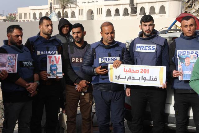 Members of the press stand in solidarity after an Israeli missile hit a media broadcast truck in Nuseirat, on December 26, 2024, outside the Baptist Hospital in Gaza City, amid the ongoing war between Israel and the Palestinian Hamas movement. Palestinian TV channel affiliated with a militant group said five of its journalists were killed on December 26, in an Israeli strike on their vehicle in Gaza, with Israel's military saying it had targeted a "terrorist cell". (Photo by Omar AL-QATTAA / AFP)